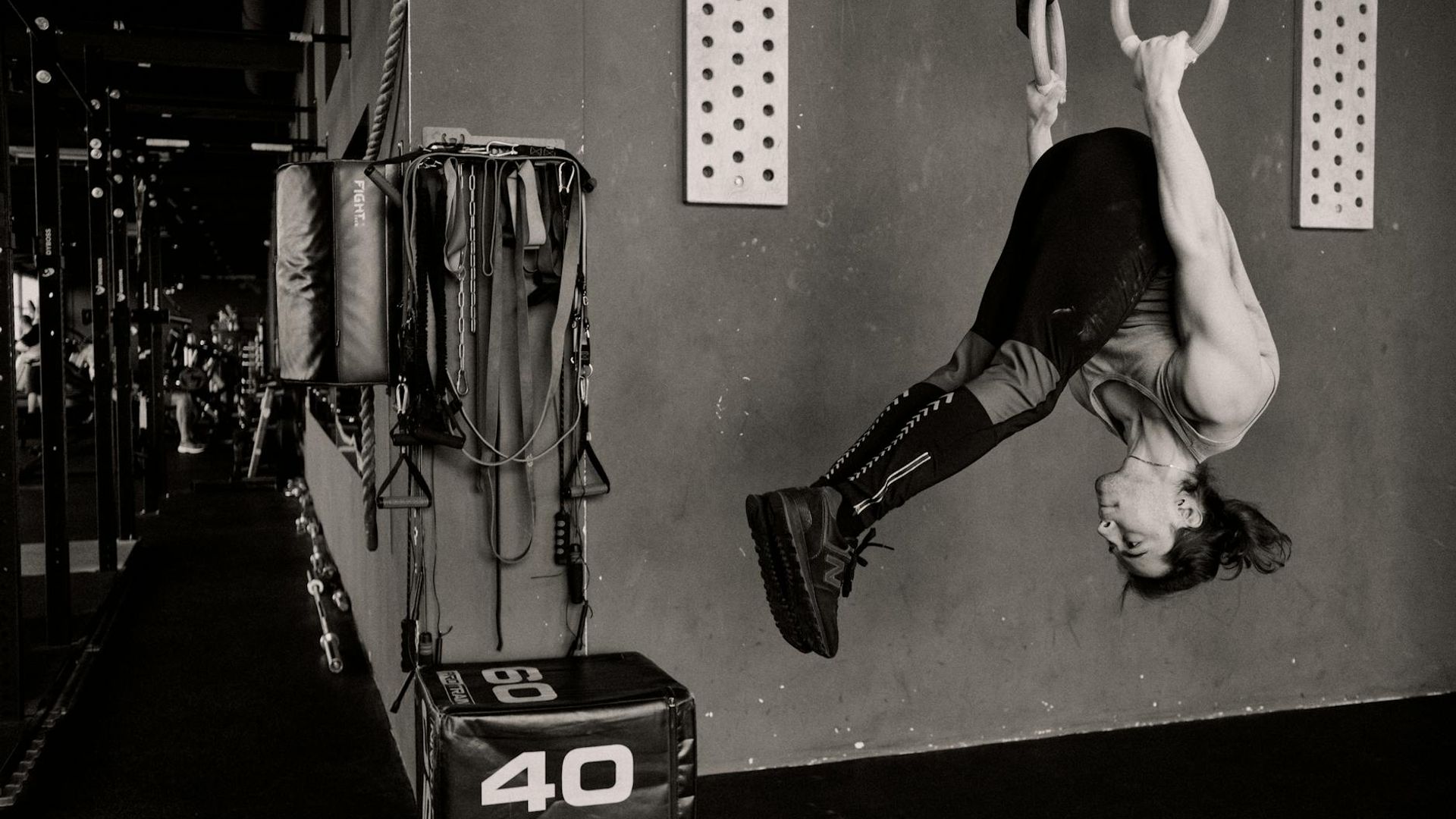 Man performing a controlled bodyweight exercise in a minimalist gym.